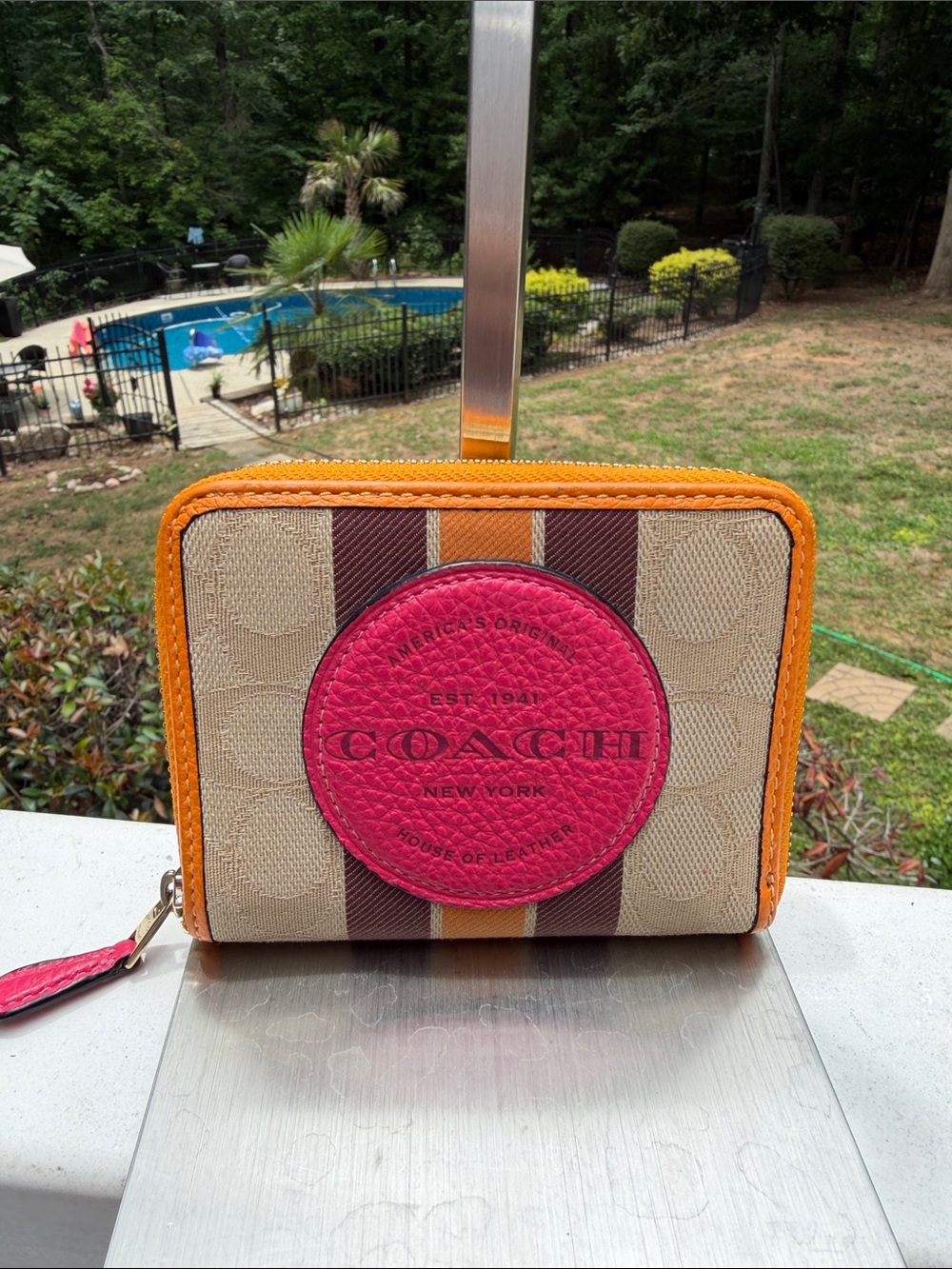 Coach Dempsey zip around in  Signature Jacquard Canvas with a pink leather logo